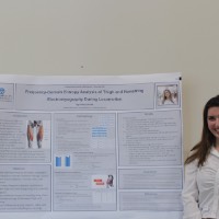A student standing next to a muscle testing project.
